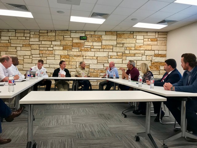 Chief Nim Kidd, Commissioner John Sharp, and Governor Greg Abbott meet with local officials at Sam and Carmena Goss Library.