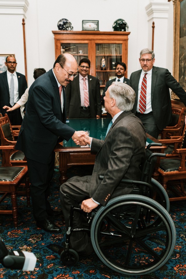Governor Abbott shakes hands and discusses a strong economic and cultural ties between Texas and India with Ambassador Harsh Shringla.